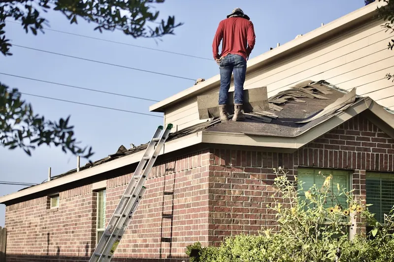 Professional roofer working on a residential roof in Marion
